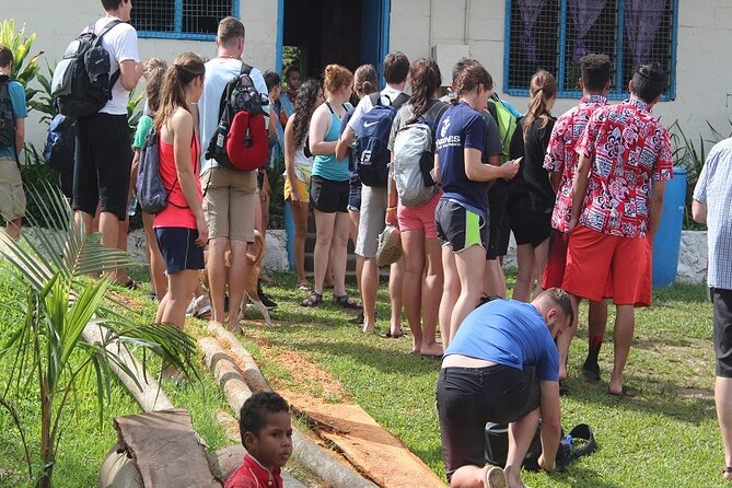 Waterfall and Fijian Village Tour with Light Lunch ex Nadi Area Hotels - Entering a Fijian village through a kava welcome